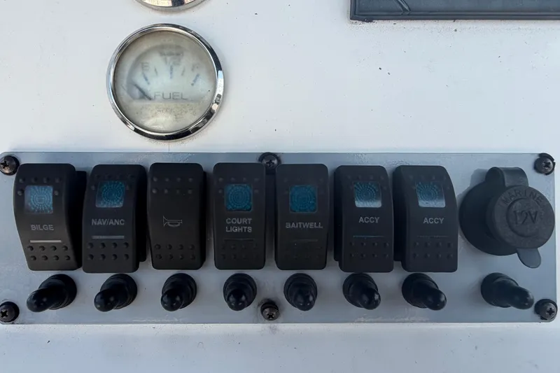 Slide: The Image of Control panel of a 2019 Sea Born SV19 Bay boat with switches and fuel gauge. - 19