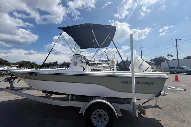 Slide: The Image of 2019 Sea Born SV19 Bay boat on trailer under blue sky. - 6