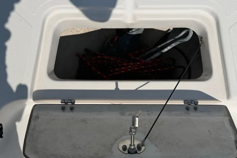 Slide: The Image of An open storage compartment on a boat with rope and anchor inside. - 30