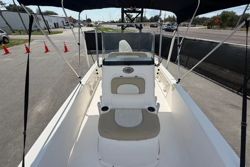 Slide: The Image of 2019 Sea Born SV19 Bay boat interior with seating and console, parked outdoors. - 36
