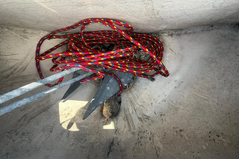 Slide: The Image of An anchor with a colorful rope lies in a boat. - 34
