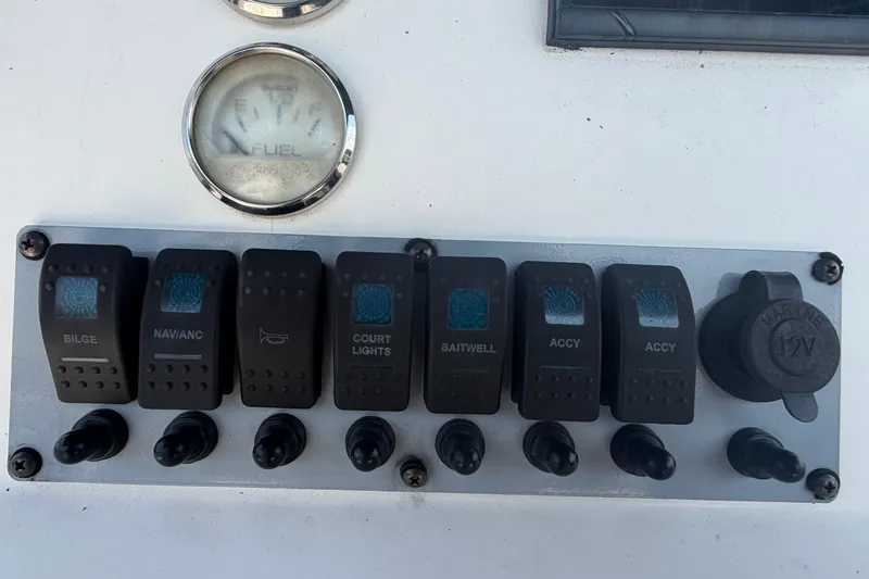 Slide: The Image of Control panel of a 2019 Sea Born SV19 Bay boat with switches and fuel gauge. - 17