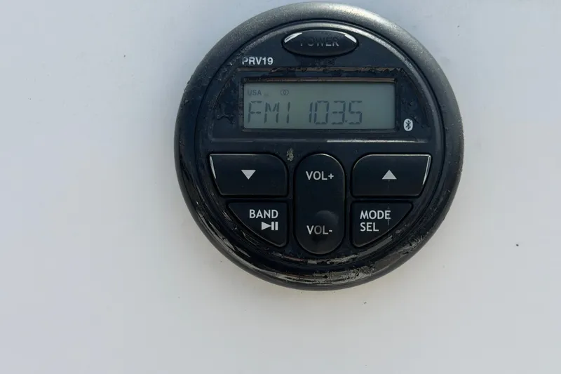 Slide: The Image of Boat radio display showing FM 103.5 on a 2019 Sea Born SV19 Bay. - 18