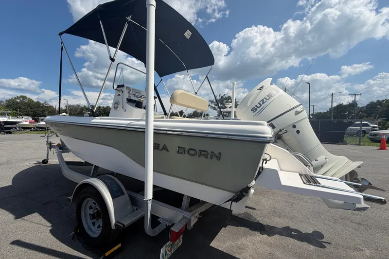 Slide: The Image of 2019 Sea Born SV19 Bay boat with Suzuki outboard motor on trailer under blue sky. - 5
