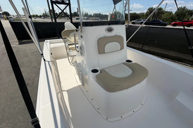 Slide: The Image of 2019 Sea Born SV19 Bay boat interior with seating and console, parked outdoors. - 42