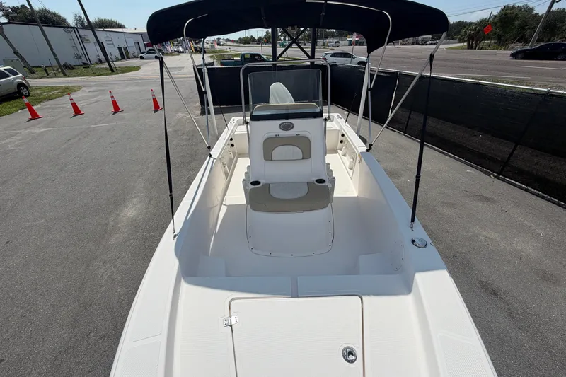 Slide: The Image of 2019 Sea Born SV19 Bay boat with canopy, parked on pavement near traffic cones. - 31