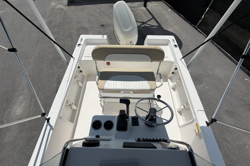 Slide: The Image of The image shows the cockpit of a 2019 Sea Born SV19 Bay boat with a helm and bench seat. - 44