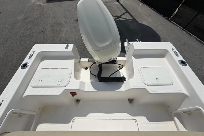Slide: The Image of The image shows the stern of a 2019 Sea Born SV19 Bay boat with an outboard motor. - 48