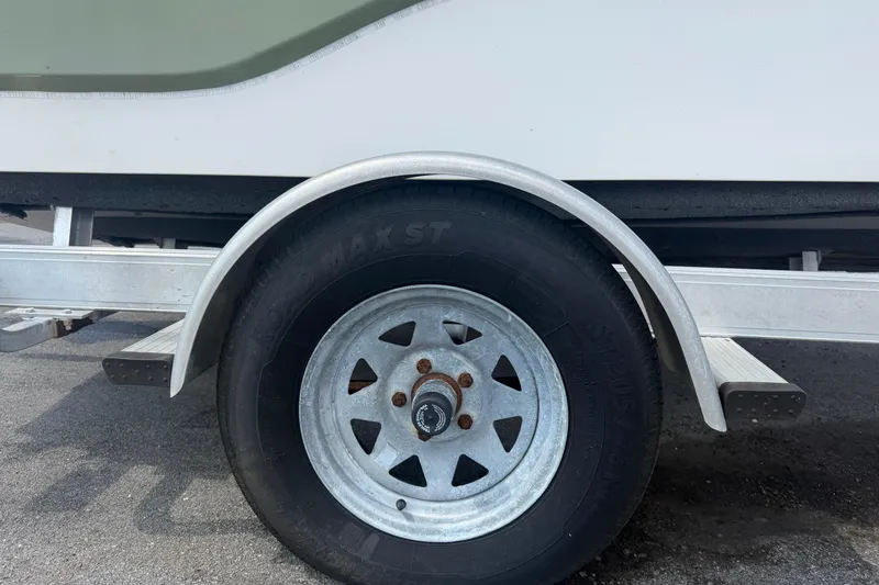 Slide: The Image of Trailer wheel of a 2019 Sea Born SV19 Bay boat on pavement. - 60