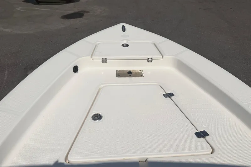 Slide: The Image of 2019 Sea Born SV19 Bay boat deck with storage compartments and clean white finish. - 27