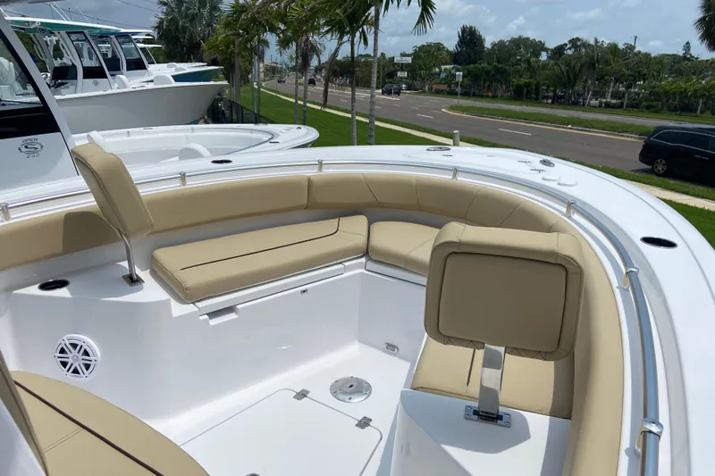 Slide: The Image of 2027 Sportsman Heritage 231 Center Console boat with beige seating and sleek design. - 28