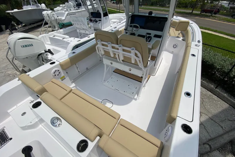 Slide: The Image of 2027 Sportsman Heritage 231 Center Console boat with beige seating and Yamaha engine. - 3