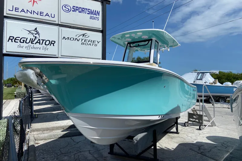 The Image of 2027 Sportsman Heritage 231 Center Console boat displayed outdoors under clear sky. - 0