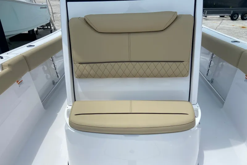 Slide: The Image of 2027 Sportsman Heritage 231 Center Console boat seating with beige cushions and diamond stitching. - 31