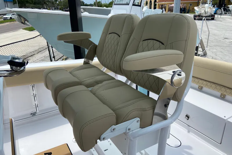 Slide: The Image of 2027 Sportsman Heritage 231 Center Console boat with dual cushioned seats and armrests. - 15