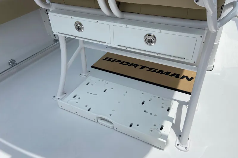 Slide: The Image of 2027 Sportsman Heritage 231 Center Console boat interior with storage compartments and branded mat. - 9