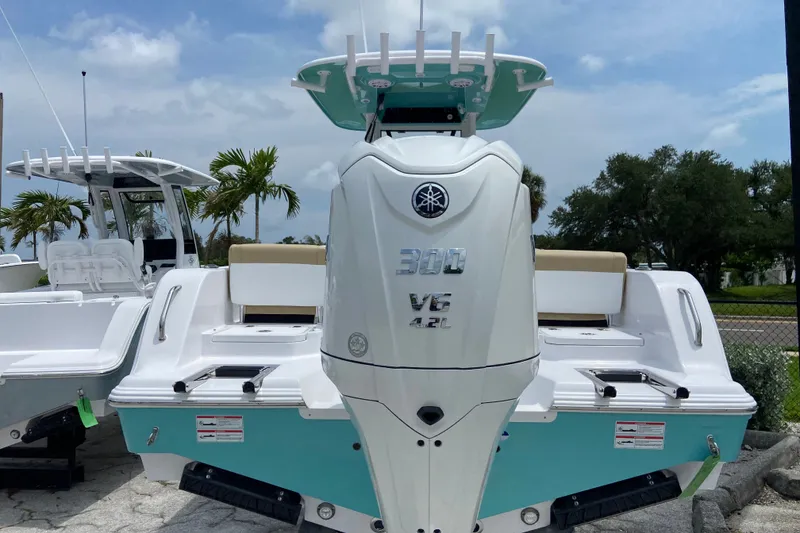 Slide: The Image of 2027 Sportsman Heritage 231 Center Console boat with Yamaha 300 V6 engine, docked outdoors. - 1