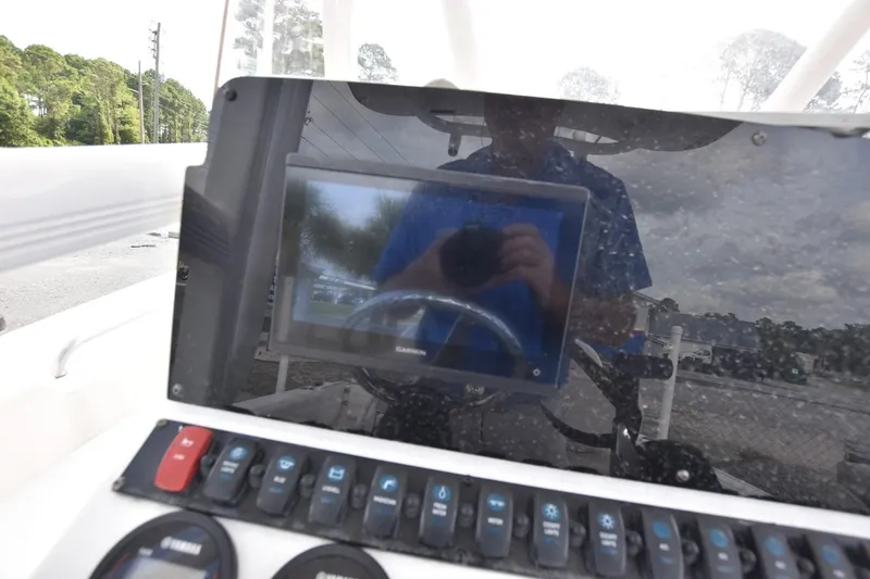 Slide: The Image of Console of 2023 Sea Hunt Ultra 229 boat with Garmin display and control panel. - 7