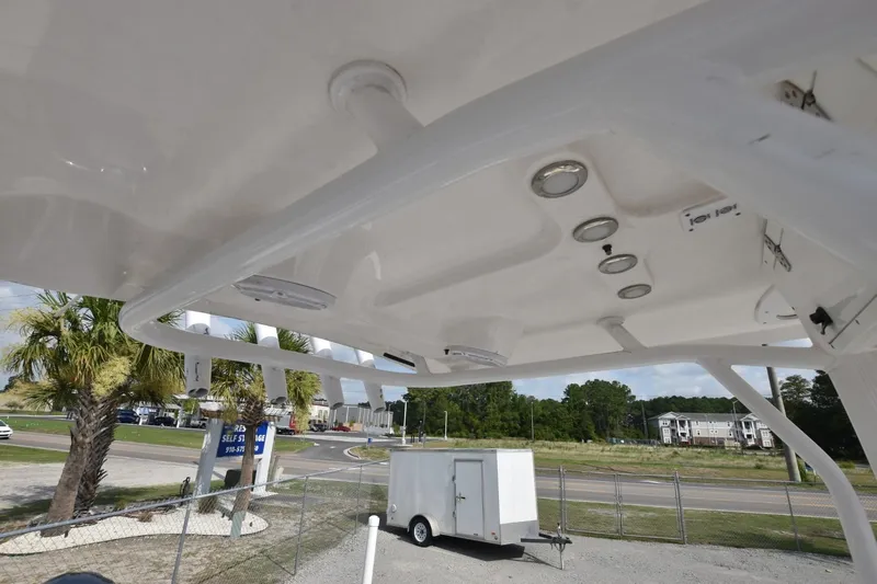 Slide: The Image of 2023 Sea Hunt Ultra 229 boat canopy with built-in lights and rod holders. - 9