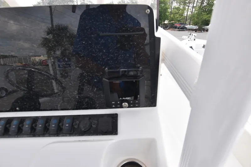 Slide: The Image of Control panel of a 2023 Sea Hunt Ultra 229 boat with switches and display. - 6