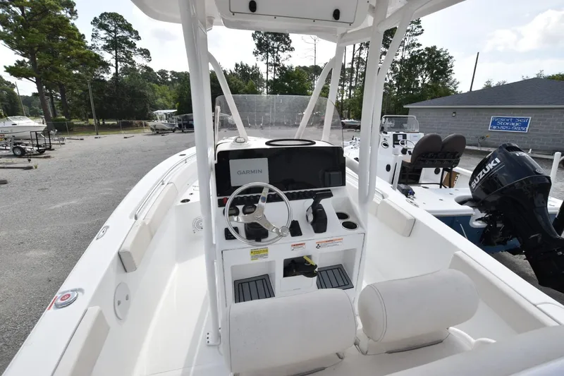Slide: The Image of 2023 Sea Hunt Ultra 229 boat interior with Garmin navigation system and Suzuki engine. - 5