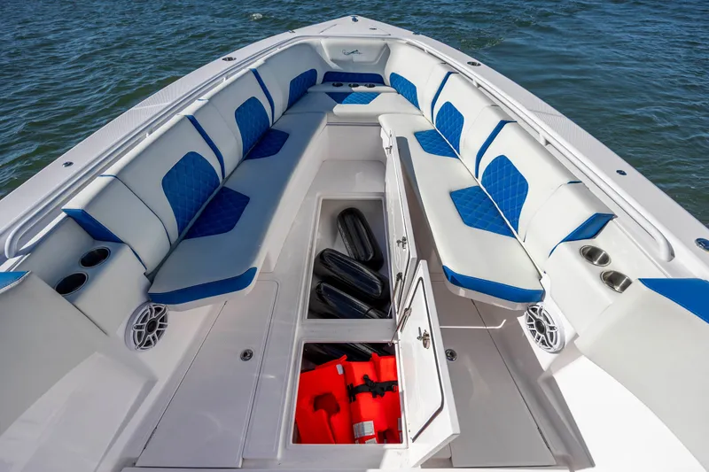 Slide: The Image of 2022 Blackwater 36 Sport boat interior with blue and white seating, open storage compartments. - 24