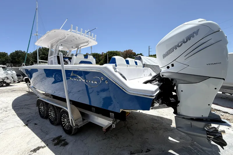 Slide: The Image of 2022 Blackwater 36 Sport boat with Mercury Verado engine, parked on a trailer. - 36