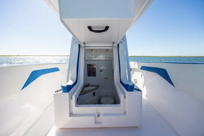 Slide: The Image of 2022 Blackwater 36 Sport boat interior with ocean view, featuring sleek design and blue accents. - 20