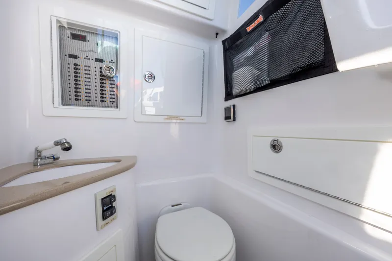 Slide: The Image of Interior of 2022 Blackwater 36 Sport boat featuring a compact bathroom with sink and toilet. - 23