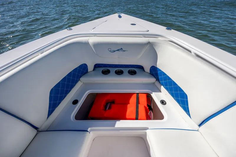 Slide: The Image of Bow seating area of 2022 Blackwater 36 Sport boat with storage compartment. - 27