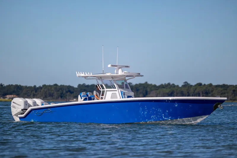 Slide: The Image of 2022 Blackwater 36 Sport boat on water, featuring sleek blue design and powerful engines. - 43
