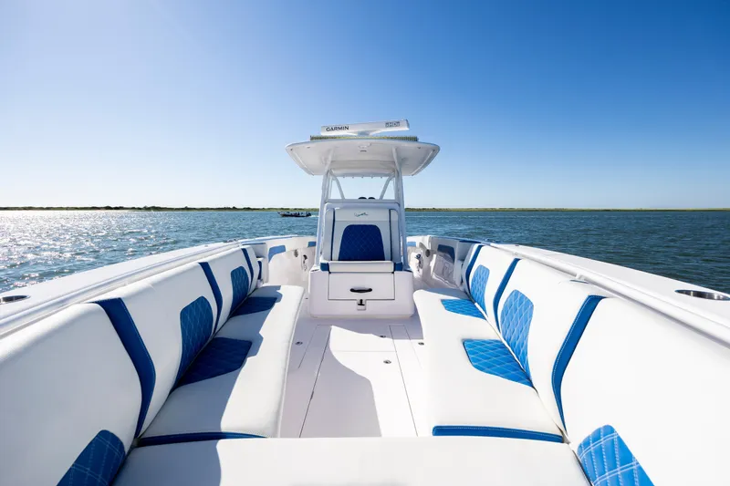 Slide: The Image of 2022 Blackwater 36 Sport boat with blue and white seating on open water. - 18