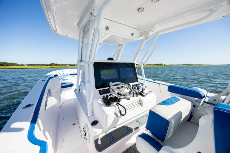 Slide: The Image of 2022 Blackwater 36 Sport boat interior with blue accents on open water. - 12
