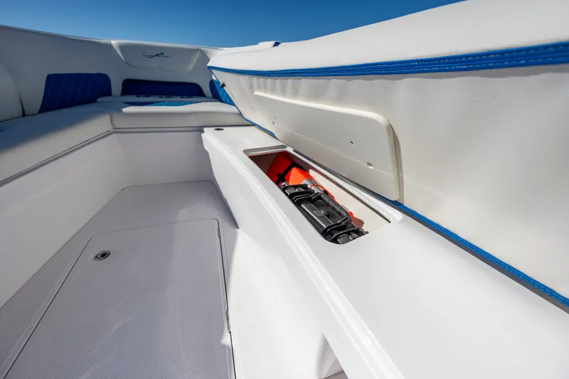 Slide: The Image of Interior storage compartment of 2022 Blackwater 36 Sport boat, featuring sleek white and blue design. - 26