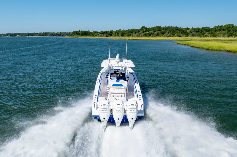 Slide: The Image of 2022 Blackwater 36 Sport boat cruising on a scenic waterway. - 53