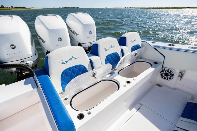 Slide: The Image of 2022 Blackwater 36 Sport boat with Mercury engines and blue seating on open water. - 35
