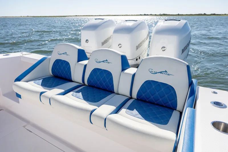 Slide: The Image of 2022 Blackwater 36 Sport boat with blue seating and triple Mercury engines on the water. - 6