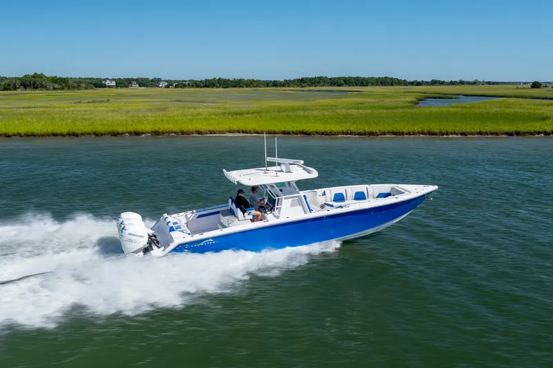 Slide: The Image of 2022 Blackwater 36 Sport boat cruising on a scenic waterway. - 57