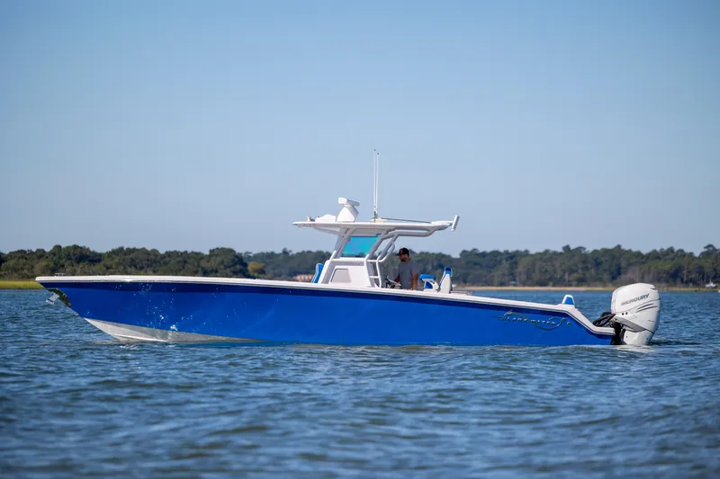 Slide: The Image of 2022 Blackwater 36 Sport boat cruising on calm waters under clear blue skies. - 47