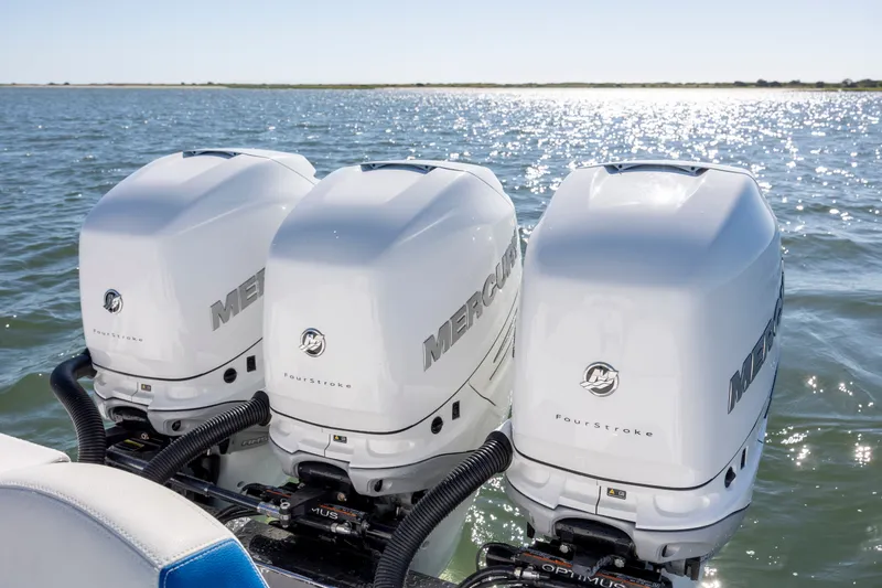 Slide: The Image of Triple Mercury outboard engines on a 2022 Blackwater 36 Sport boat in sunny waters. - 7