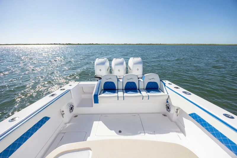 Slide: The Image of 2022 Blackwater 36 Sport boat on open water, featuring triple outboard engines. - 5