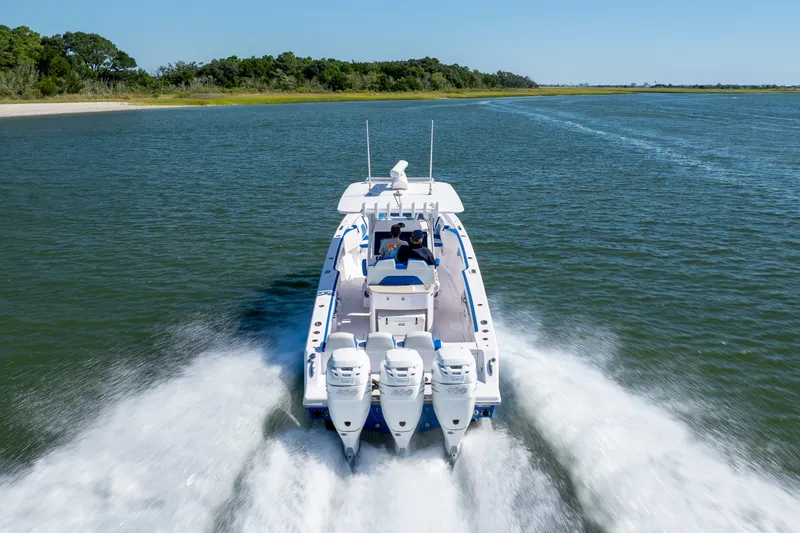 Slide: The Image of 2022 Blackwater 36 Sport boat cruising on open water, rear view. - 56