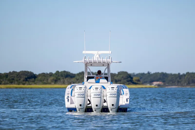 Slide: The Image of 2022 Blackwater 36 Sport boat with triple 400 engines cruising on a calm lake. - 49