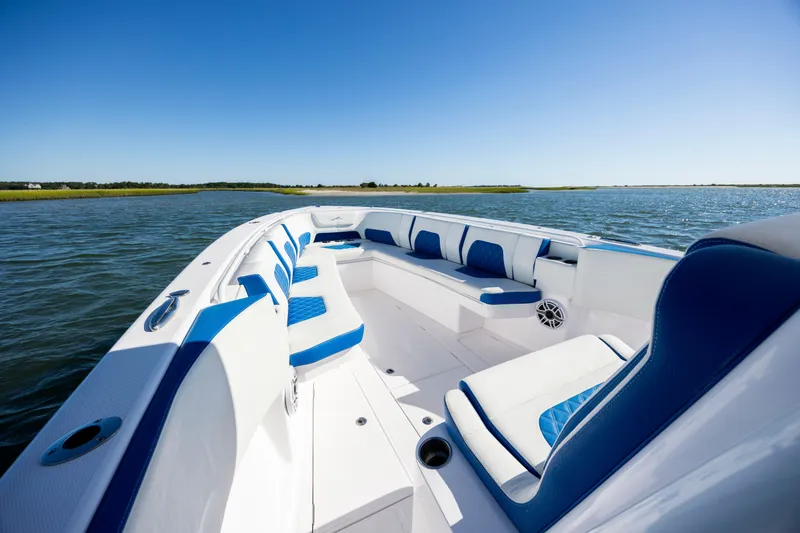 Slide: The Image of 2022 Blackwater 36 Sport boat with blue and white seating on open water. - 16