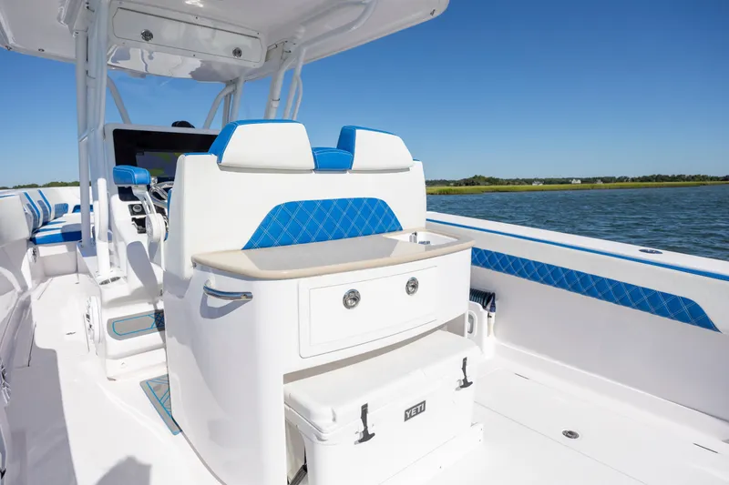 Slide: The Image of 2022 Blackwater 36 Sport boat interior with blue accents on a sunny day. - 9