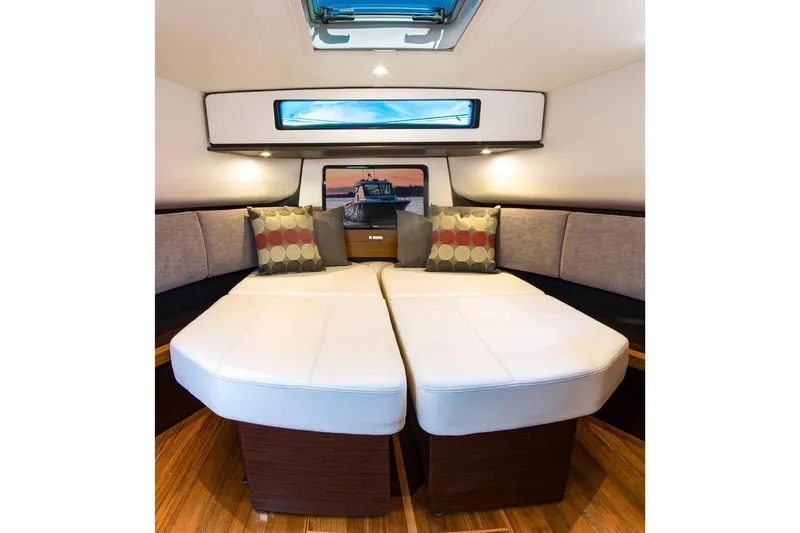 Slide: The Image of Manufacturer Provided Image: 2018 Tiara Yachts Q44 interior cabin with twin beds and decorative pillows. - 10