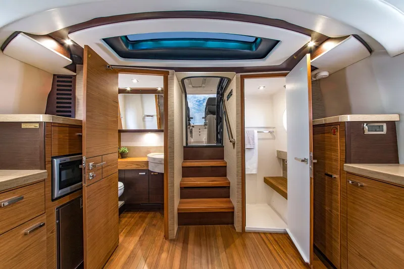 Slide: The Image of Manufacturer Provided Image: Luxurious interior of 2018 Tiara Yachts Q44 with wooden flooring and modern amenities. - 9