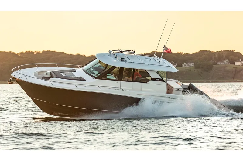 Slide: The Image of Manufacturer Provided Image: 2018 Tiara Yachts Q44 cruising on water at sunset. - 1
