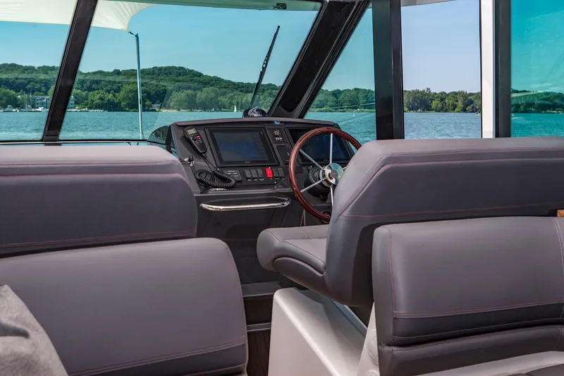 Slide: The Image of Manufacturer Provided Image: 2018 Tiara Yachts Q44 helm station with leather seats and navigation system. - 5