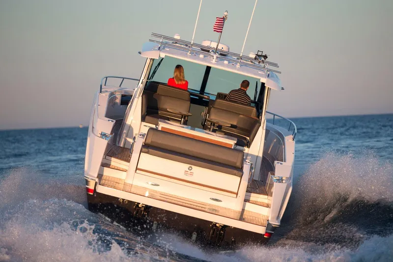 Slide: The Image of Manufacturer Provided Image: 2018 Tiara Yachts Q44 cruising on the ocean with two passengers. - 2